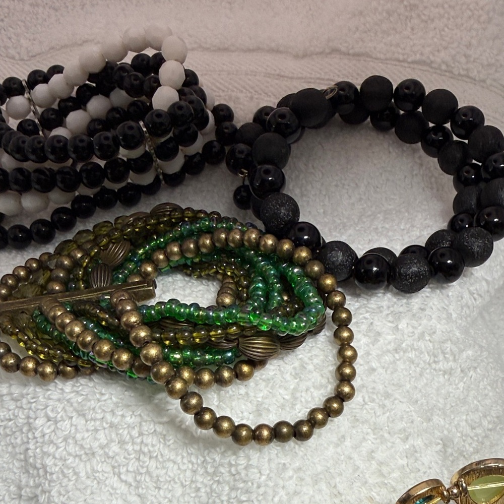 3 fun bracelets. 1 all black on memory wire. 2 stretch cuff styles